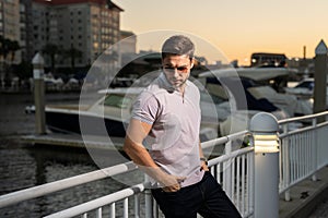 Stylish man wearing sunglasses and shirt. Handsome man outdoors portrait. Portrait of stylish male model outdoor