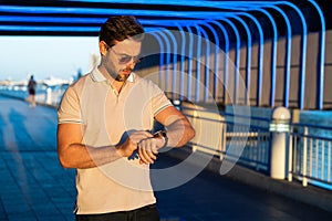 Stylish man wearing sunglasses and shirt. Handsome man outdoors portrait. Portrait of stylish male model outdoor