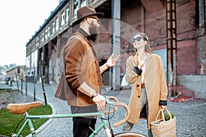 Stylish man and woman with retro bicycle outdoors