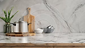 Stylish marble tabletop on wooden platform with copyspace for your logo at blurry kitchen utensils and dishes on light wall