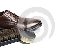 Stylish men`s footwear and shoe care accessories on white