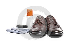 Stylish men`s footwear and shoe care accessories on white