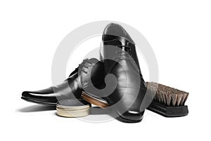 Stylish men`s footwear and shoe care accessories on white