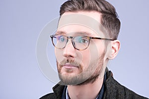 Stylish men`s glasses. Closeup portrait of young man with beard