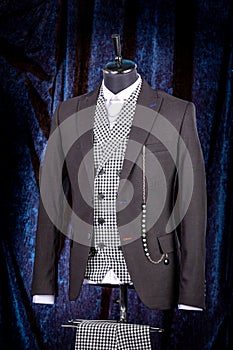 Stylish men`s gray check suit on a mannequin or dummy. Men`s Clothing. Clothing store. Shopping in boutiques