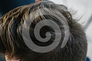 Stylish men`s hairstyle close-up. Hair brown
