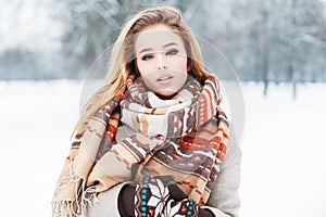 Stylish model girl in fashionable clothes with a scarf standing