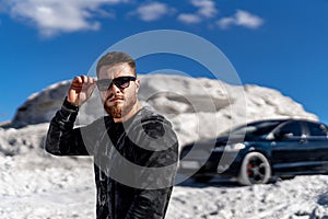 Stylish model posing with car. Young handsome fashionable businessman.