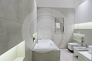 Stylish modern bathroom interior, beautiful minimalistic design with toilet, bidet, bathtub