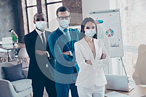 Stylish modern business trio sharks in tux folded arms wearing gauze safety masks mers cov prevention at workplace