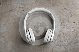 Stylish modern headphones with earmuffs on gray background