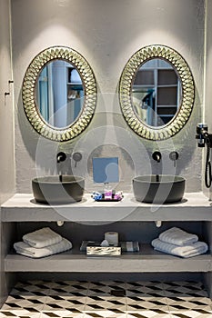 Stylish modern interior of bathroom with two black vessel sink under mirror. Elegant modern design of bathroom