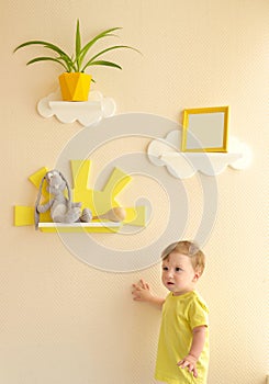 Stylish and modern Interior design. Home for the child room. todder boy takes a gray hare`s