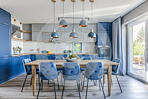 Stylish Modern Kitchen with Blue Cabinets and Elegant Dining Area