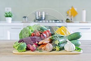 Stylish modern kitchen with vegetables on the table. Bright white kitchen with homewares. The concept of a healthy lifestyle photo