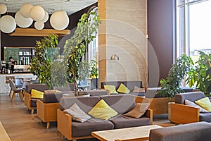 stylish modern office interior with green plants in the lobby with a bar