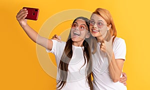 stylish mom and kid bloggers. happy woman and girl take selfie with smartphone. selfie family