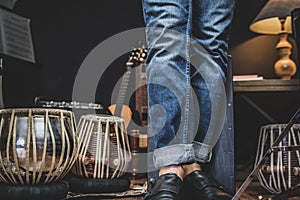 Stylish musician playing the Cajon drums.