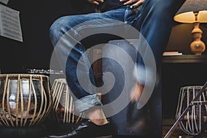 Stylish musician playing the Cajon drums.