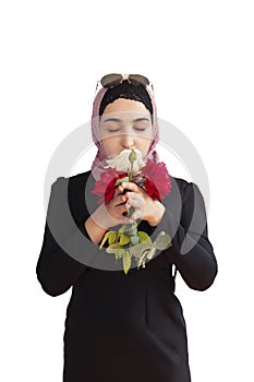 Stylish Muslim woman in traditional Islamic clothing holding flower bouquet. Portrait of beautiful middle-eastern girl in Hijab.