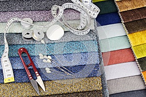 Stylish natural linen fabric and sewing accessories. The basis for sewing clothes. Flat layout, close-up, top view, copy