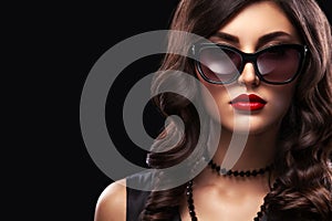 Stylish night flash fashion portrait of trendy casual young woman in black dress.
