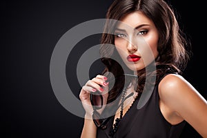 Stylish night flash fashion portrait of trendy casual young woman in black dress.