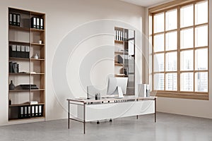 Stylish office interior with workplace, pc computer and window. Mock up wall