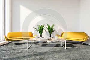 Stylish office lounge with yellow couches
