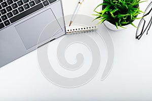 Stylish office table desk. Workspace with laptop, diary, succulent on white background. Flat lay, top view with copy space for tex photo