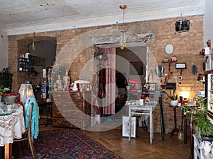 Stylish old vintage interior design. Wooden furniture. Brick wall. A lot of retro home decor.