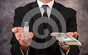 a stylish older man in a suit carries the vaccine in a jar and dollars for it.