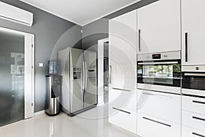 Stylish open plan kitchen with silver fridge