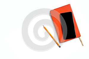 Stylish orange day planner with leather cover, smartphone and a pencil isolated on white background