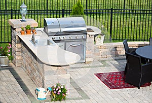 Stylish outdoor kitchen on a brick patio