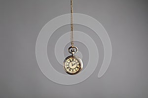 Stylish pendulum on grey background. Hypnotherapy session