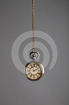 Stylish pendulum on grey background. Hypnotherapy session