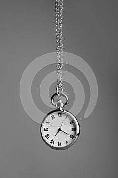 Stylish pendulum on grey background. Hypnotherapy session