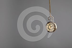 Stylish pendulum on grey background, space for text. Hypnotherapy session