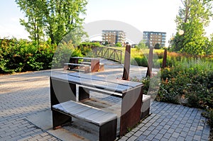 Stylish picnic tables behind apartment building