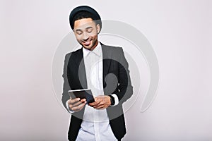 Stylish portrait elegant handsome man in white shirt and black jacket with tablet on white background. Businessman