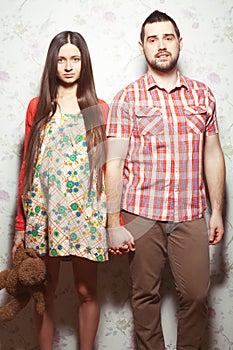 Stylish pregnancy concept: portrait of couple of hipsters husband and wife in trendy clothes shirt, dress, cardigan and jeans