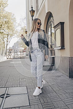 Stylish pretty model posing in the street, wearing jacket photo