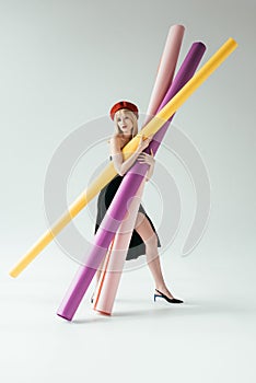 Stylish pretty woman in black dress carrying colorful