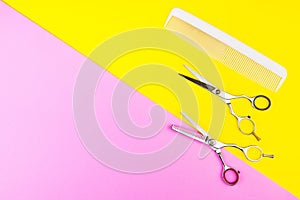 Stylish Professional Barber Scissors and comb on yellow and pink background. Hairdresser salon concept, Hairdressing Set. Haircut