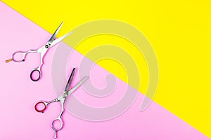 Stylish Professional Barber Scissors on yellow and pink background. Hairdresser salon concept, Hairdressing Set. Haircut