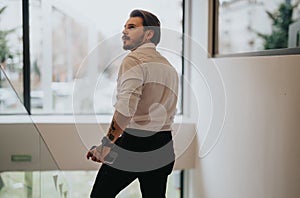 Stylish professional man contemplating in modern office environment