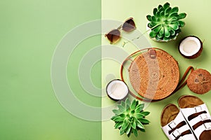 Stylish rattan bag, coconut, birkenstocks, succulent, sunglasses on yellow background. Banner. Top view with copy space