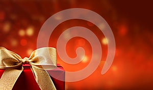 Stylish red christmas gift with golden ribbon and bow against bokeh lights background copy space Merry Christmas,festive