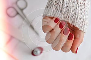 Stylish red female nails. Modern Beautiful manicure. Autumn winter nail design concept of beauty treatment. Gel nails